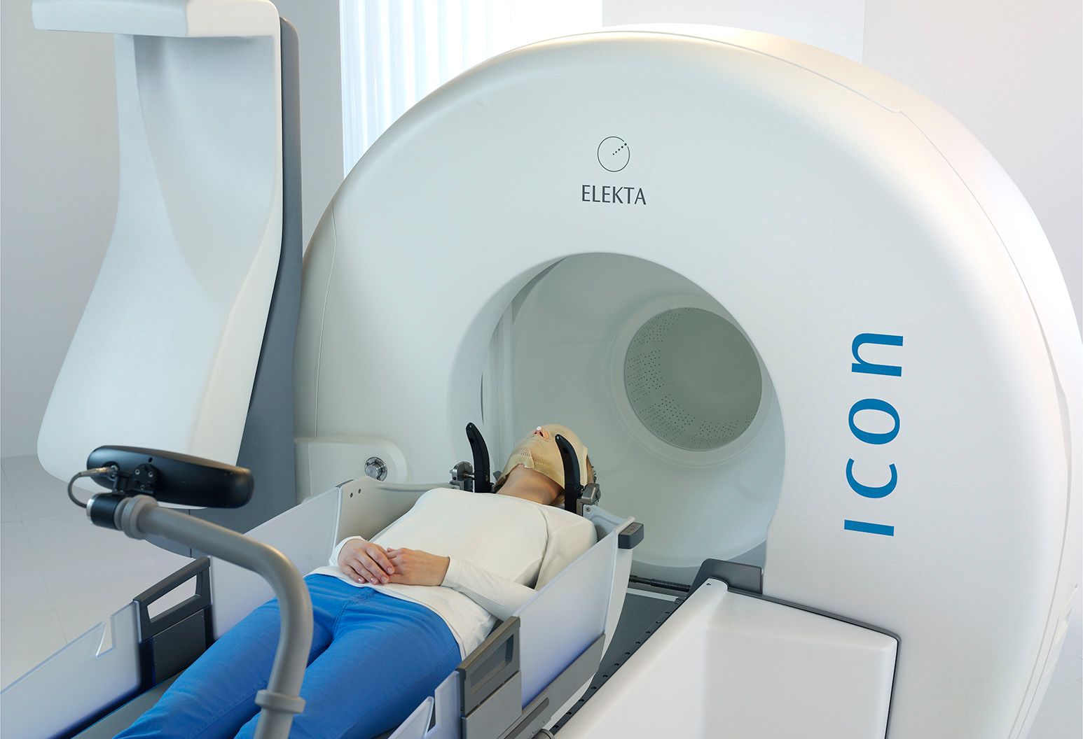 A woman laying down on a Gamma Knife Icon machine